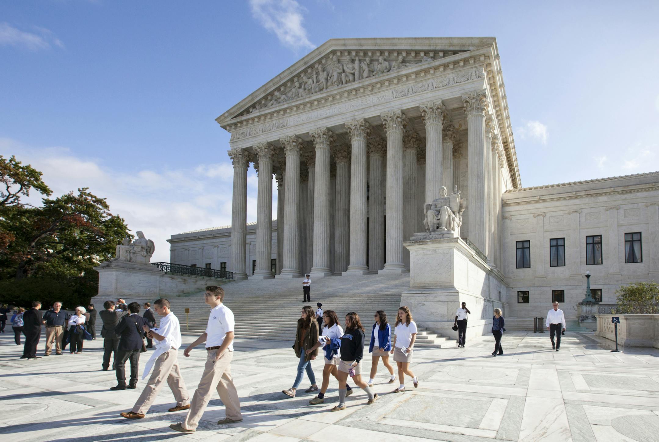 Visitors line up to enter the Supreme Court in Washington, Tuesday, Oct. 14, 2014, as it begins the second week of its new term. The landscape has changed very quickly for gay marriage in the U.S. Last week, the Supreme Court declined to hear appeals from several states seeking to retain their bans on same-sex marriage. The Oct. 6 move effectively legalized gay marriage in about 30 states and triggered a flurry of rulings and confusion in lower courts across the nation. (AP Photo/J. Scott Applew