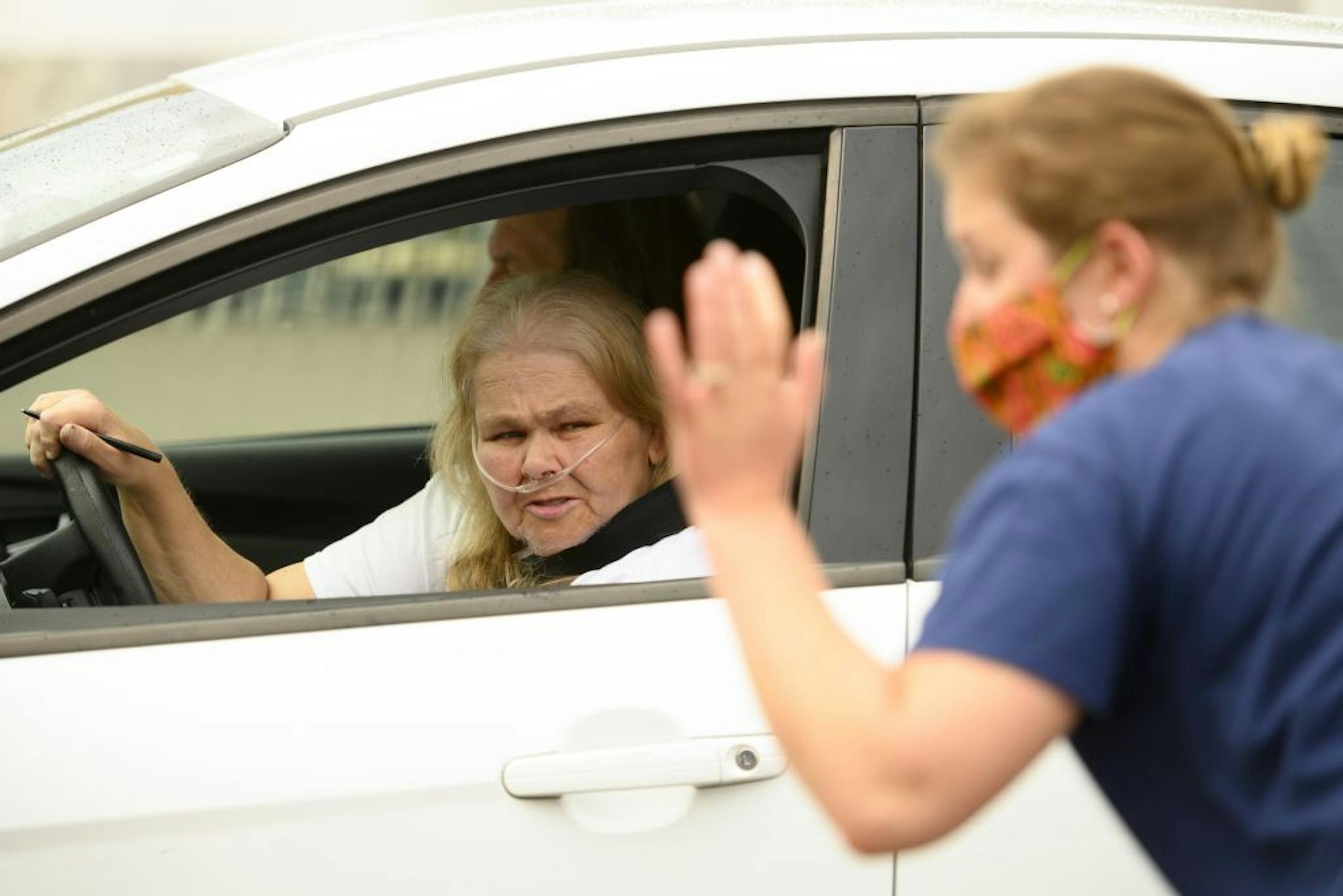 A nurse with the Minnesota Dept. of Health fielded questions from Kathryn Shanks, 71, of Brooklyn Center, while waiting in line for a free COVID-19 test Saturday. Shanks has COPD and was inquiring about follow-up testing opportunities. .