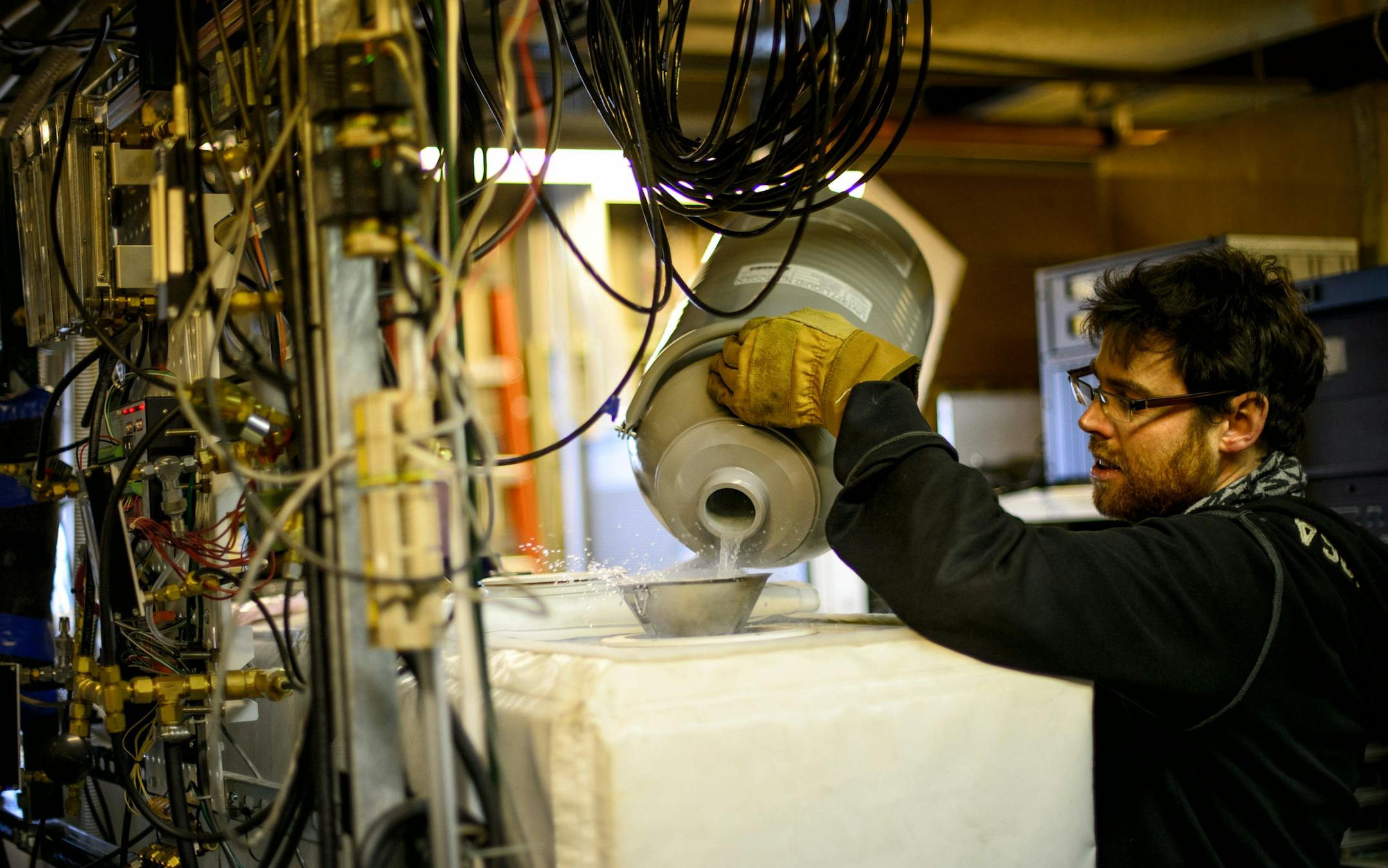 University of Minnesota research assistant Jeff Wood added liquid nitrogen to cool lasers used to analyze chemical components during their atmospheric science research at UMore Park in Rosemount. They are researching the carbon balance of agricultural systems there. ] GLEN STUBBE * gstubbe@startribune.com Monday, February 23, 2015