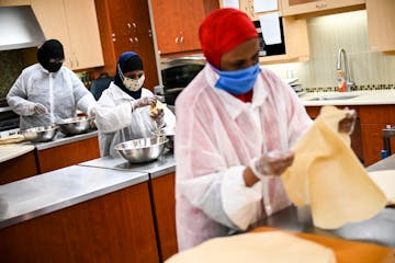 From left, Asha Mohamed, Ayan Shire and Nimo Abdullahi assembled sambusas Wednesday at frozen-food business Hoyo. The business, which gives work exper