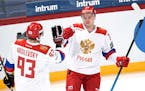 Russia's Alexei Vasilevsky, left and Kirill Kaprizov celebrate Kaprizov's opening goal during the Hockey Euro Hockey Tour Karjala Cup match between Cz