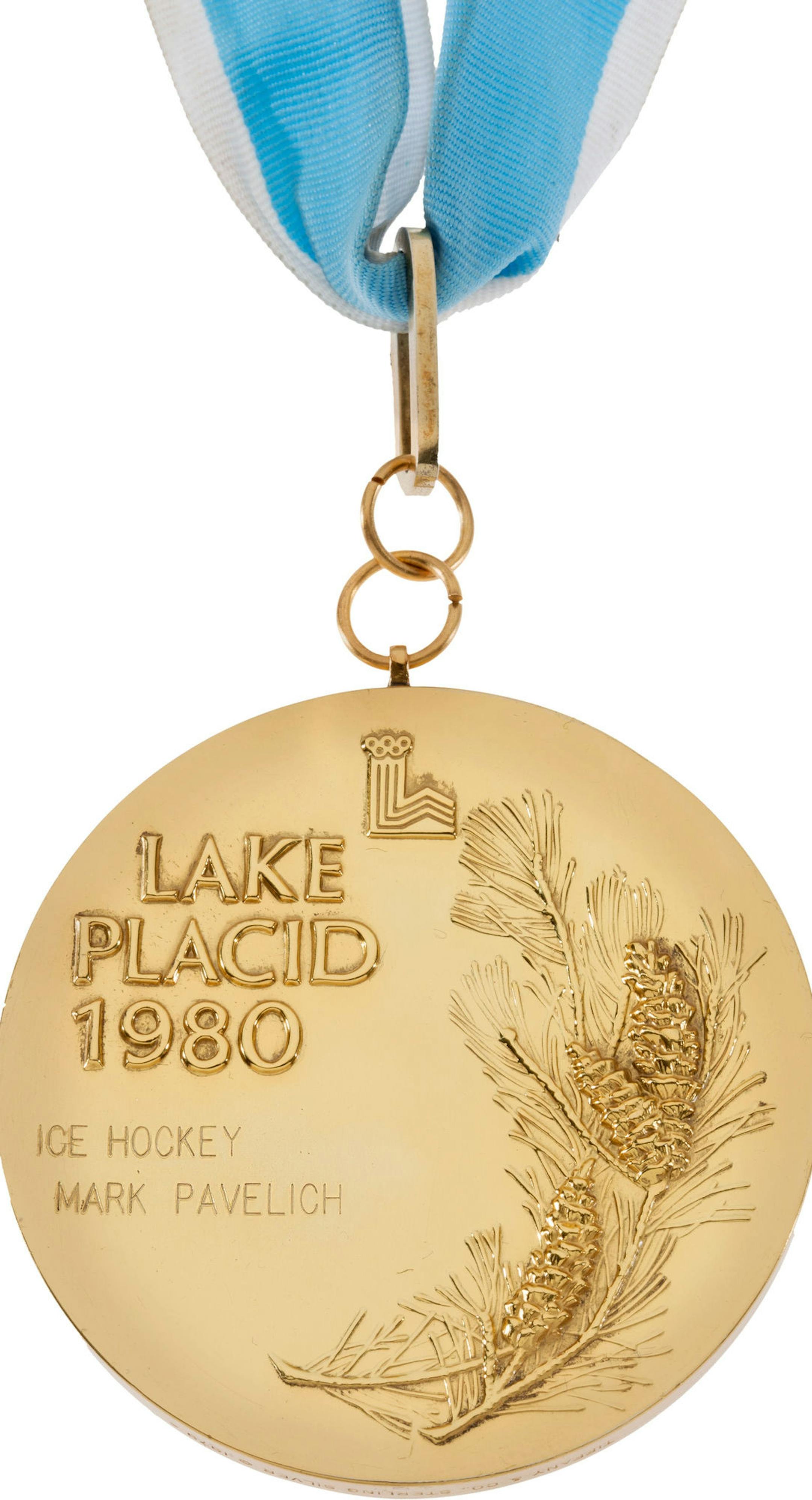 This photo provided by Heritage Auctions shows the Lake Placid 1980 winter Olympic gold medal of U.S. ice hockey player Mark Pavelich. Heritage Auctions of Dallas says it fetched $262,900 in an online-only sale on Friday, May 16, 2014. The company says it&#xed;s just the second 1980 U.S. Olympic hockey gold medal to reach the block, the first being Mark Wells' medal, which commanded $310,700 in 2010. (AP Photo/Heritage Auctions) ORG XMIT: NY152