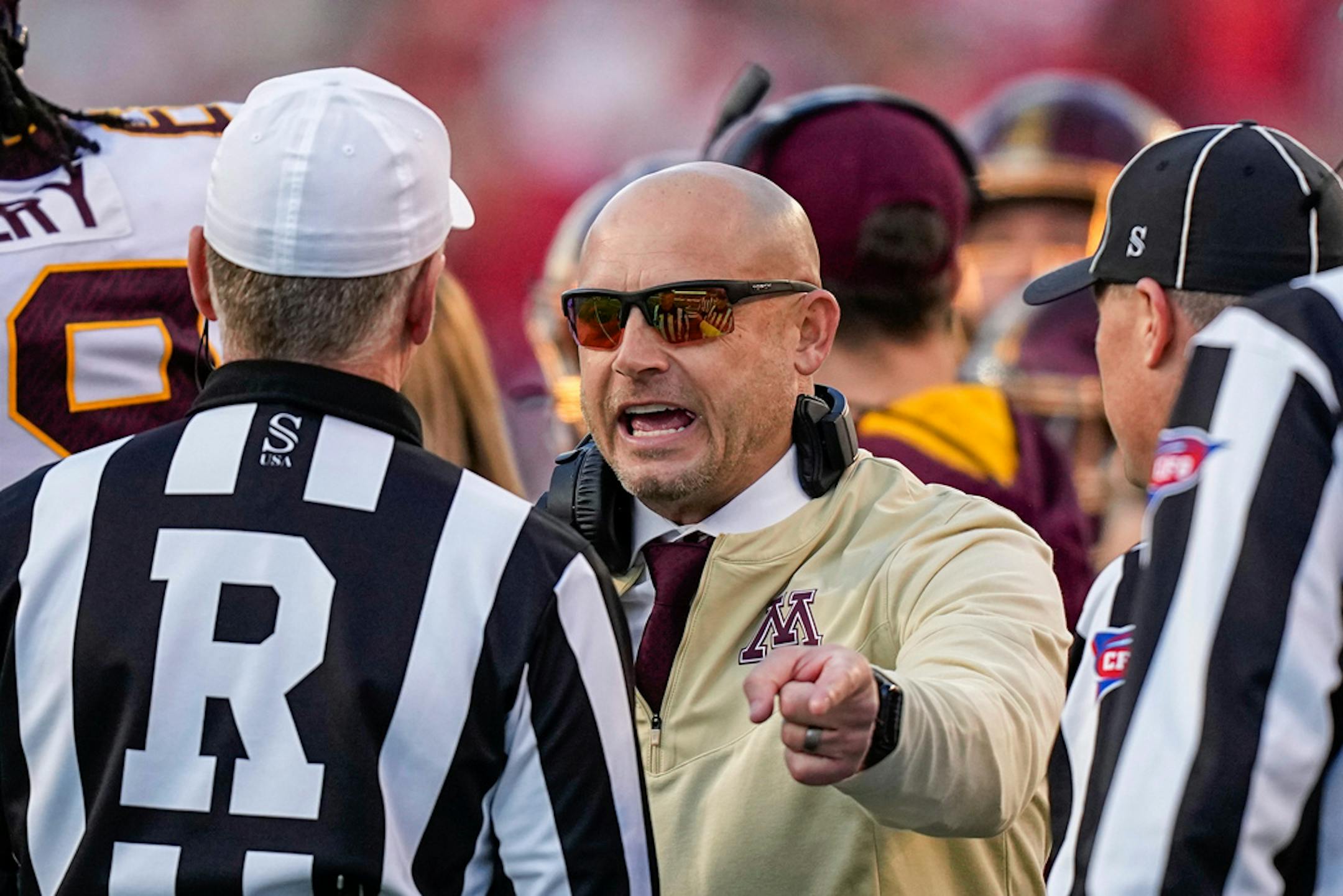 Minnesota coach P.J. Fleck talks with officials during a timeout in the first half of the team's NCAA college football game against Wisconsin on Saturday, Nov. 26, 2022, in Madison, Wis. Minnesota won 23-16. (AP Photo/Andy Manis)