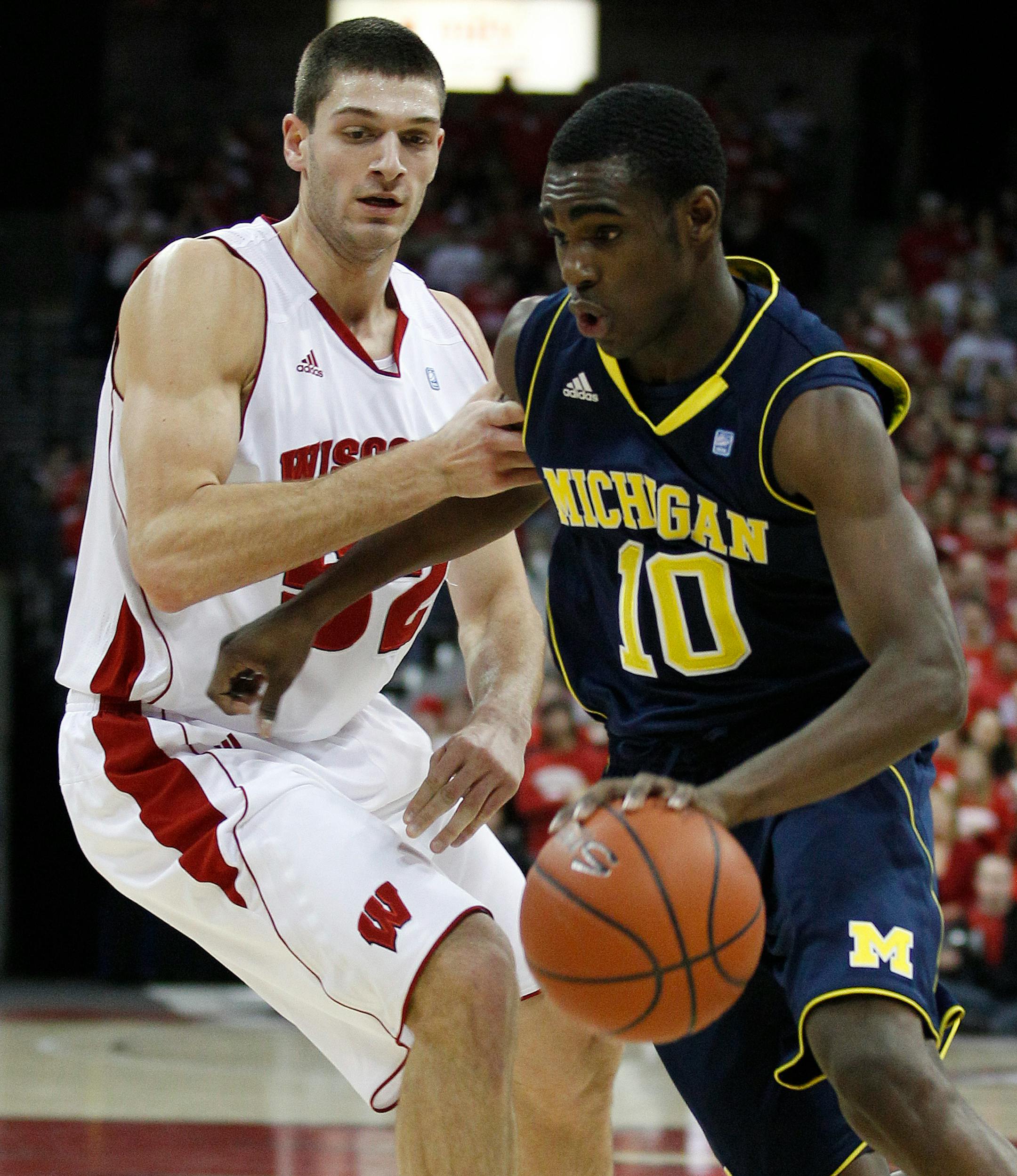 Michigan's Tim Hardaway Jr. (10) tries to drive past Wisconsin's Keaton Nankivil (52) during the first half of an NCAA college basketball game Wednesday, Jan. 5, 2011, in Madison, Wis. (AP Photo/Morry Gash)