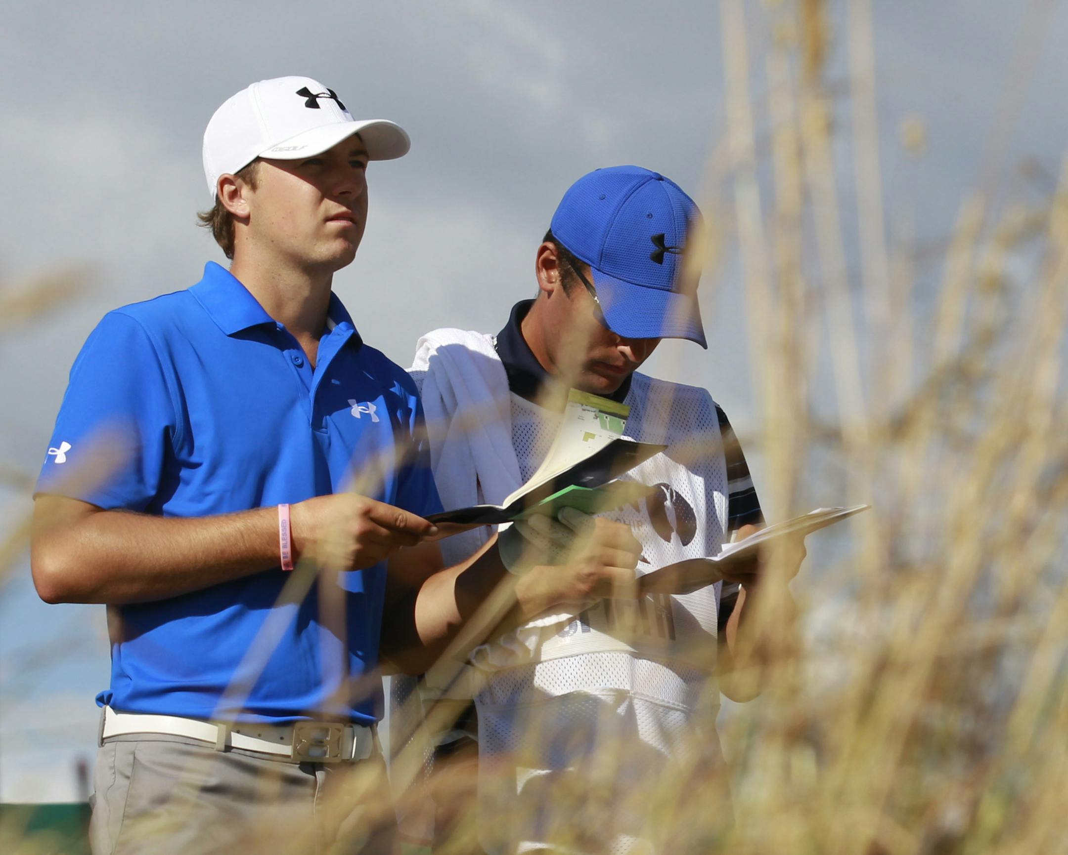 Jordan Spieth of the United States prepares to play off the 18th tee with his caddie during the first round of the British Open Golf Championship at Muirfield, Scotland, Thursday July 18, 2013. (AP Photo/Peter Morrison)