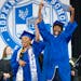 Two seniors dance and celebrate as they walk off the stage the Hopkins High School graduation ceremony Tuesday, June 6, 2023, at Maturi Pavilion on th