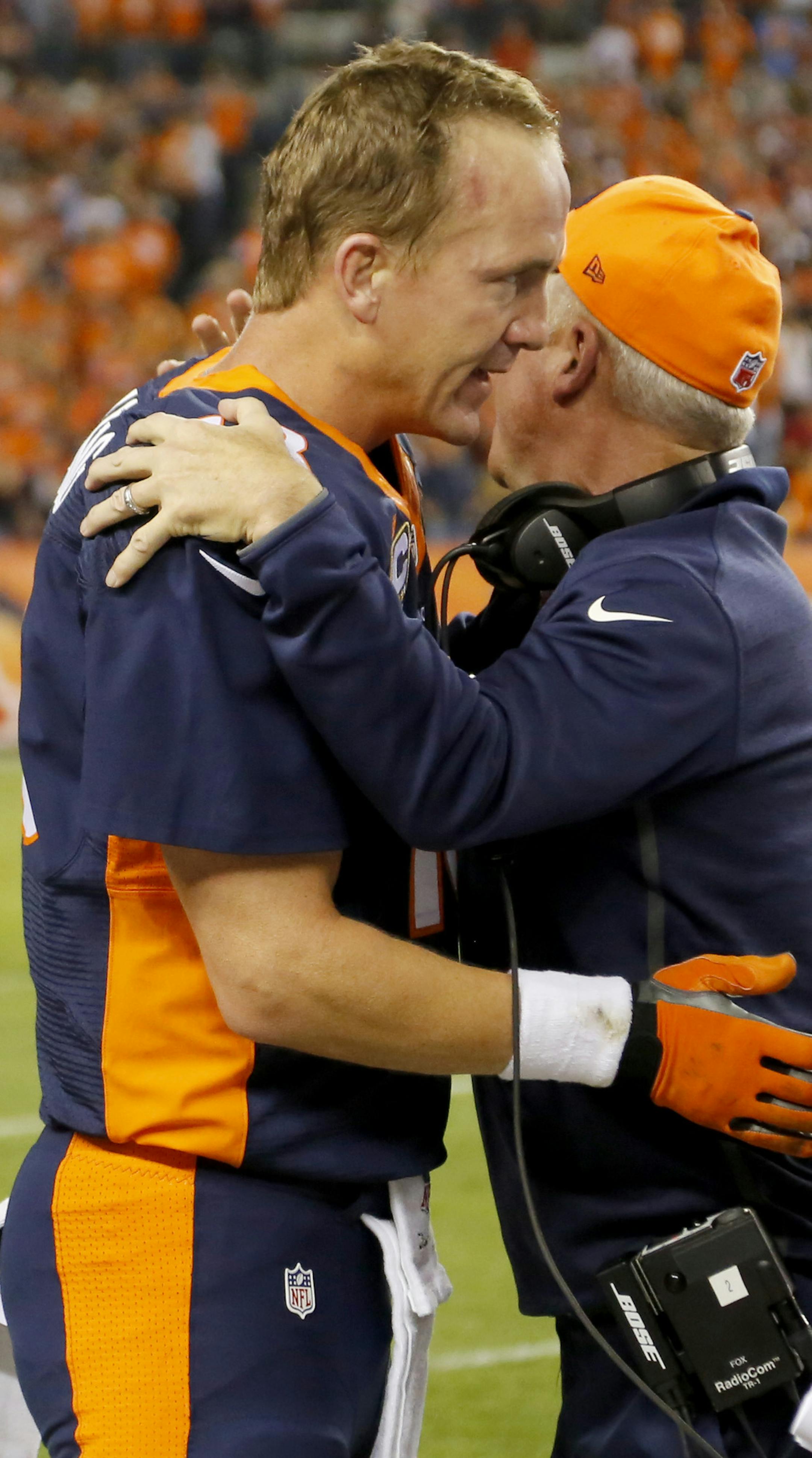 Denver Broncos quarterback Peyton Manning (18) celebrates his 509th career touchdown pass with head coach John Fox during the first half of an NFL football game against the San Francisco 49ers, Sunday, Oct. 19, 2014, in Denver. (AP Photo/Jack Dempsey)