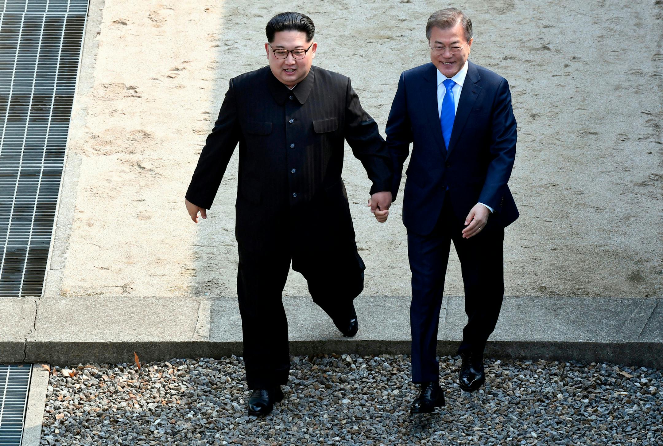 FILE - In this Friday, April 27, 2018, file photo, North Korean leader Kim Jong Un, left, and South Korean President Moon Jae-in cross the military demarcation line at the border village of Panmunjom in Demilitarized Zone, South Korea. Kim became the first North Korean leader to set foot onto South Korean land since the 1950-53 Korean War when he stepped into the southern side of the border village of Panmunjom to meet with Moon Jae-in on Friday. (Korea Summit Press Pool via AP, File)