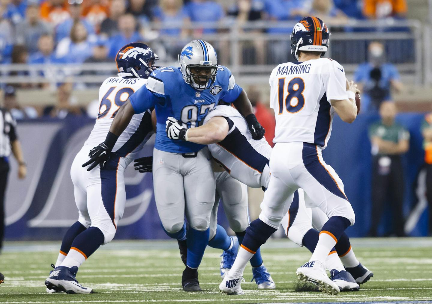 Denver Broncos quarterback Peyton Manning (18) is pressured by Detroit Lions defensive tackle Caraun Reid (97) during an NFL football game at Ford Field in Detroit, Sunday, Sept. 27, 2015. (AP Photo/Rick Osentoski) ORG XMIT: MIN2015093019160031