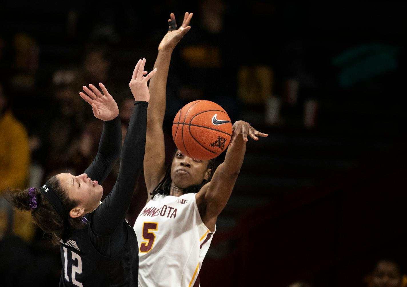 Gophers forward Taiye Bello (5) blocked the shot of Northwestern's Veronica Burton during Minnesota's 73-64 overtime victory at Williams Arena on Sunday.