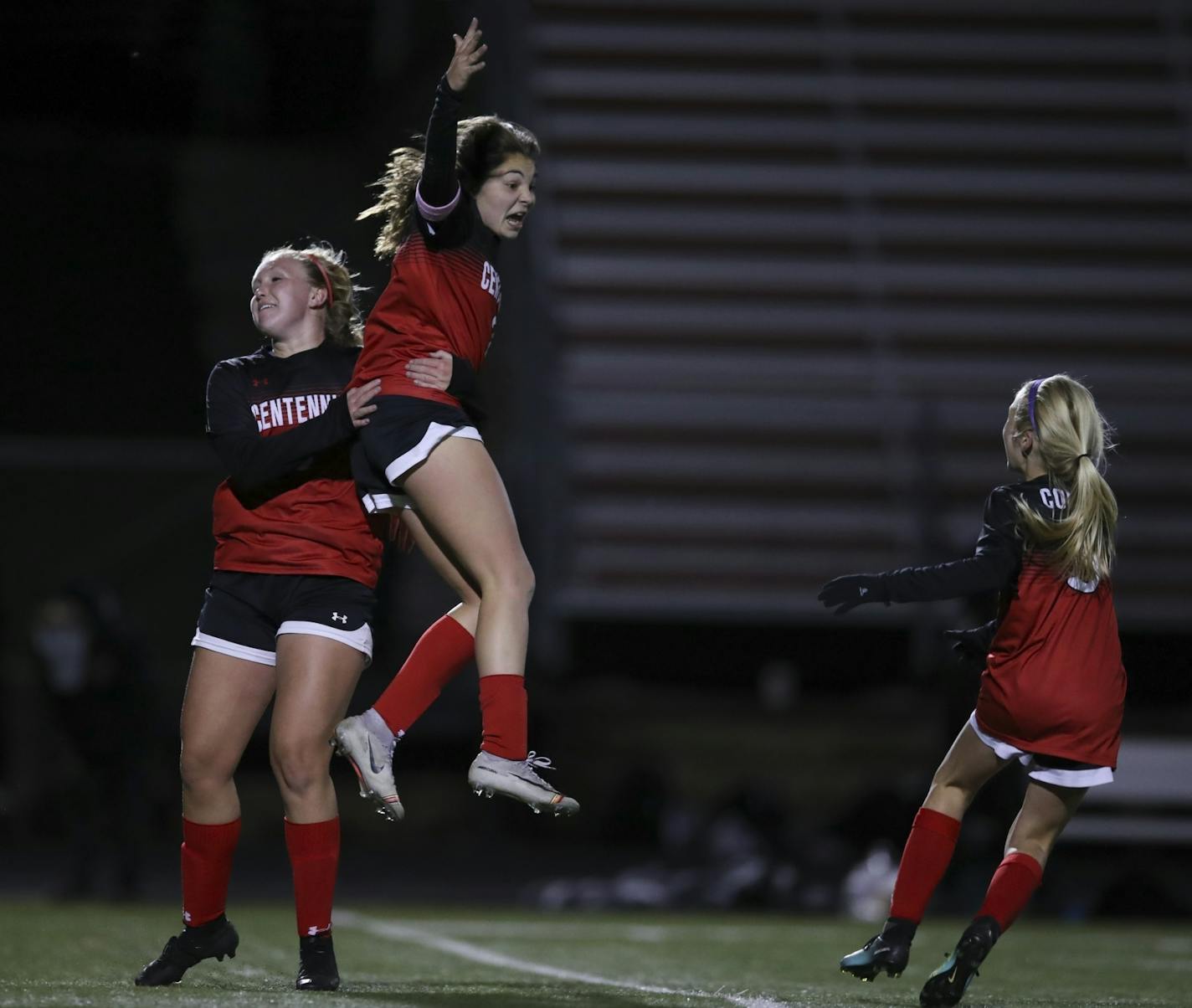 Centennial's Khyah Harper reacted after scoring the game winner in the second overtime period. With her were teammates Mallory Monson and Ally Hamski, right.