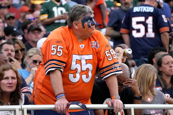 A Chicago Bears fan looks at the scoreboard during the fourth quarter of the team’s season-starting loss to Green Bay.