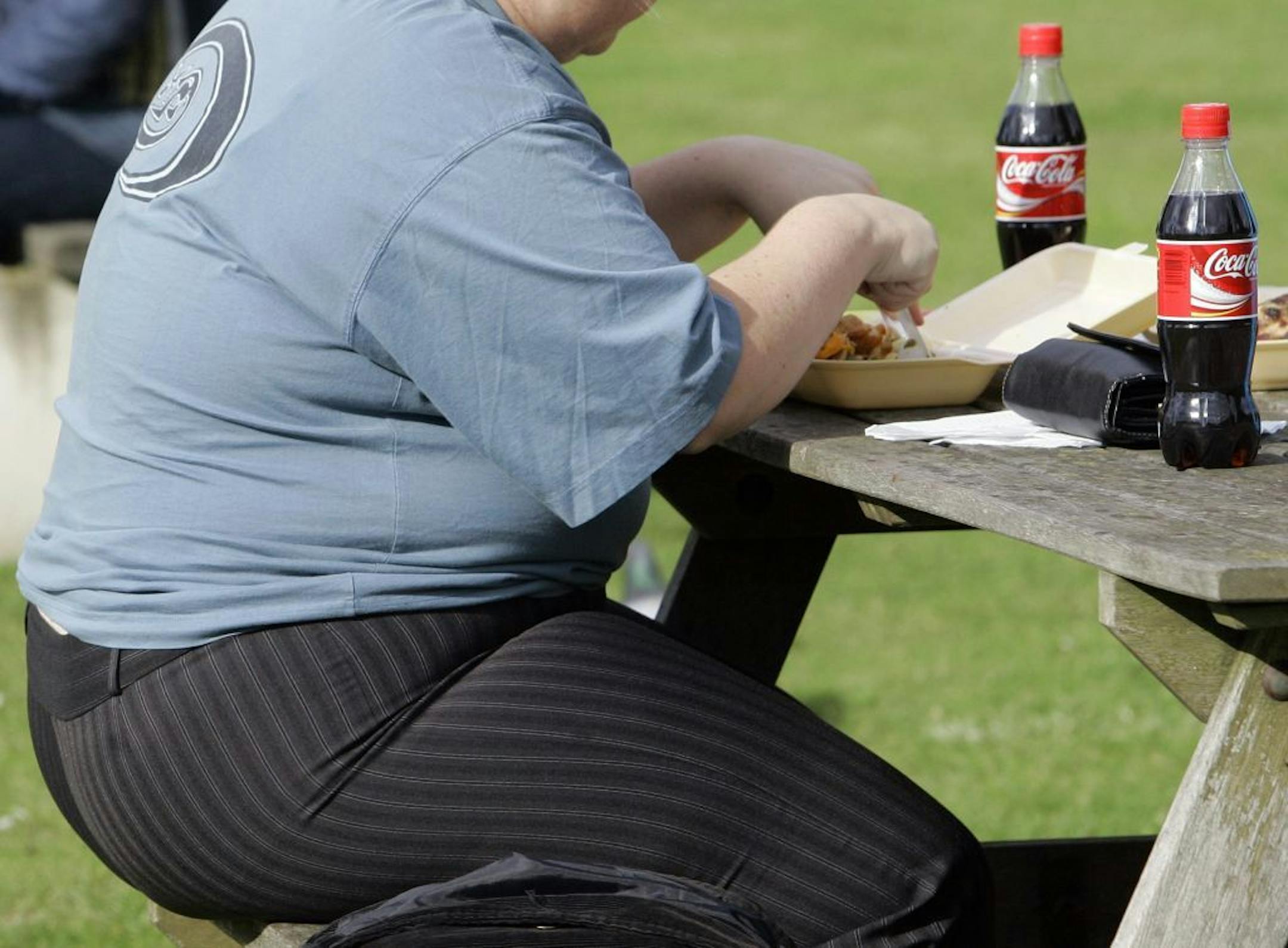 FILE -- An overweight person eats in London, Wednesday, Oct. 17, 2007.