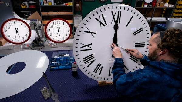 Ian Roders fastened the hands to a clock at Electric Time Co. on Tuesday in Medfield, Mass.
