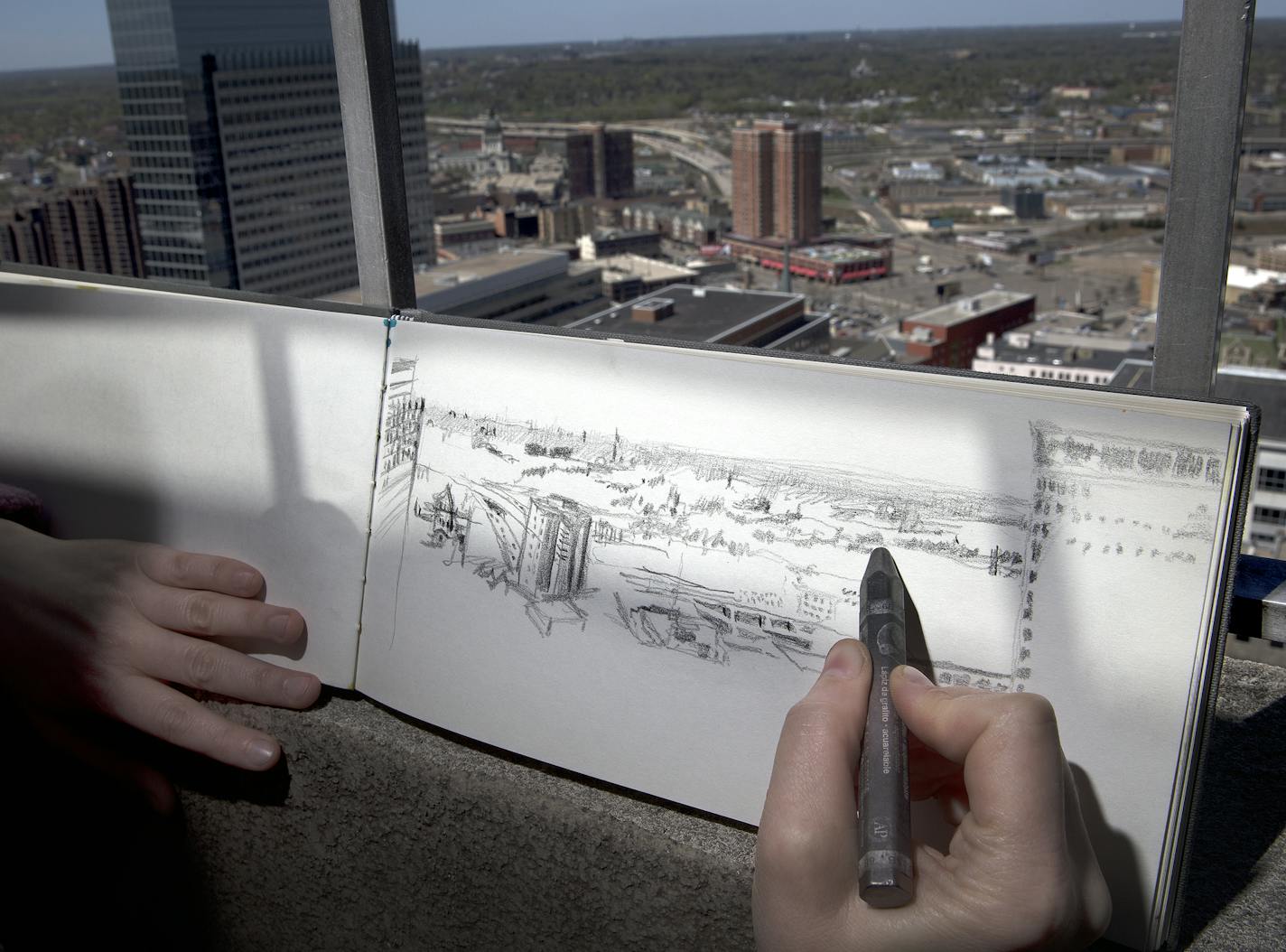 During a Minneapolis Plein Air Coterie meetup, Alex Newby worked on her pencil drawing of the western view from the top of the Foshay tower.