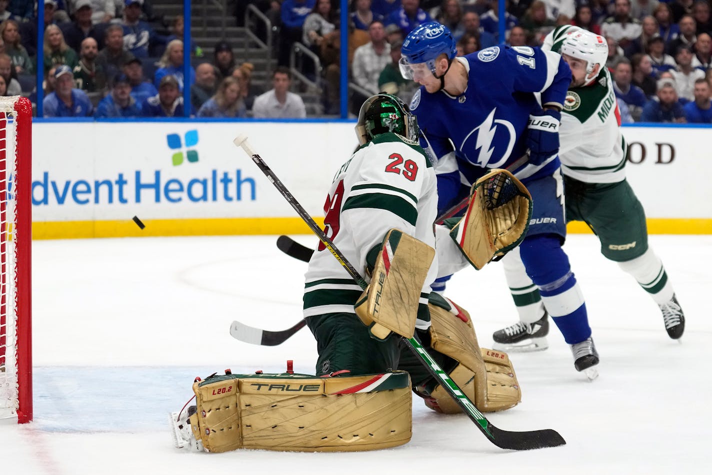 Tampa Bay right wing Corey Perry deflects the puck past Wild goaltender Marc-Andre Fleury for a goal during the second period