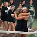 MinnetonkaÕs Kelsey Phillips (right) and Karina Elvestrom hug after they both won their singles matches of the Class 2A Team state tennis championshi