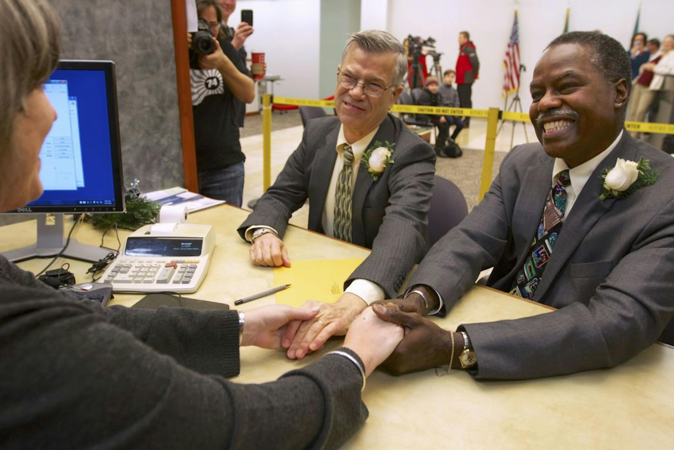 James Griener, left, and Paul Harris thank clerk June Gaylord after they were the first couple in Clark County to get a marriage license Thursday, Dec. 6, 2012 in Vancouver, Wash. Harris is a manager in the records department and arranged that the pair, who have been together for 39 years, could be first to get the paper work that will allow them to marry anytime after a 3-day waiting period. Washington state now joins several other states that allow gay and lesbian couples to wed. Gov. Chris Gr