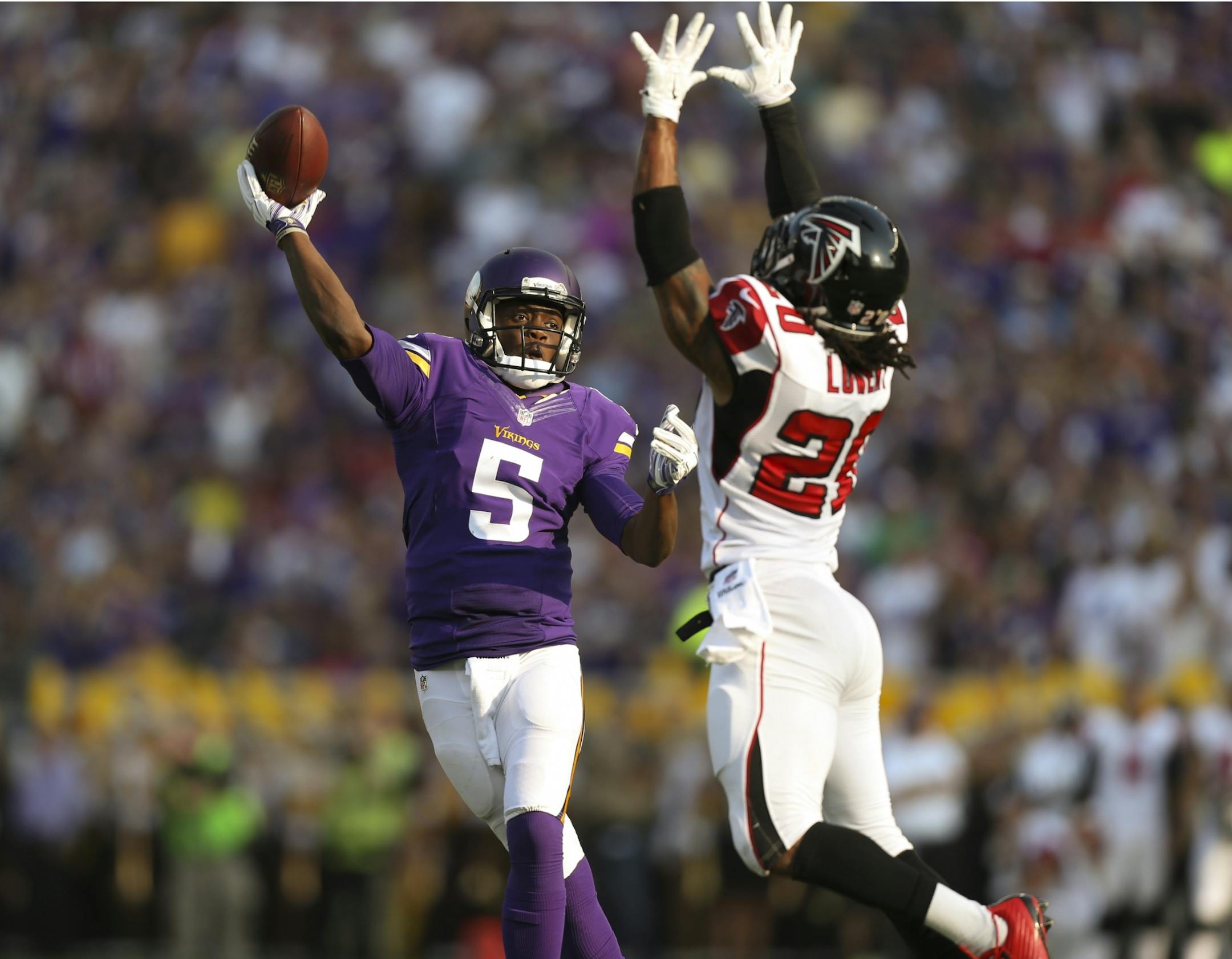 Minnesota Vikings quarterback Teddy Bridgewater (5) threw under pressure from Atlanta Falcons free safety Dwight Lowery (20) late in the second quarter Sunday afternoon at TCF Bank Stadium.