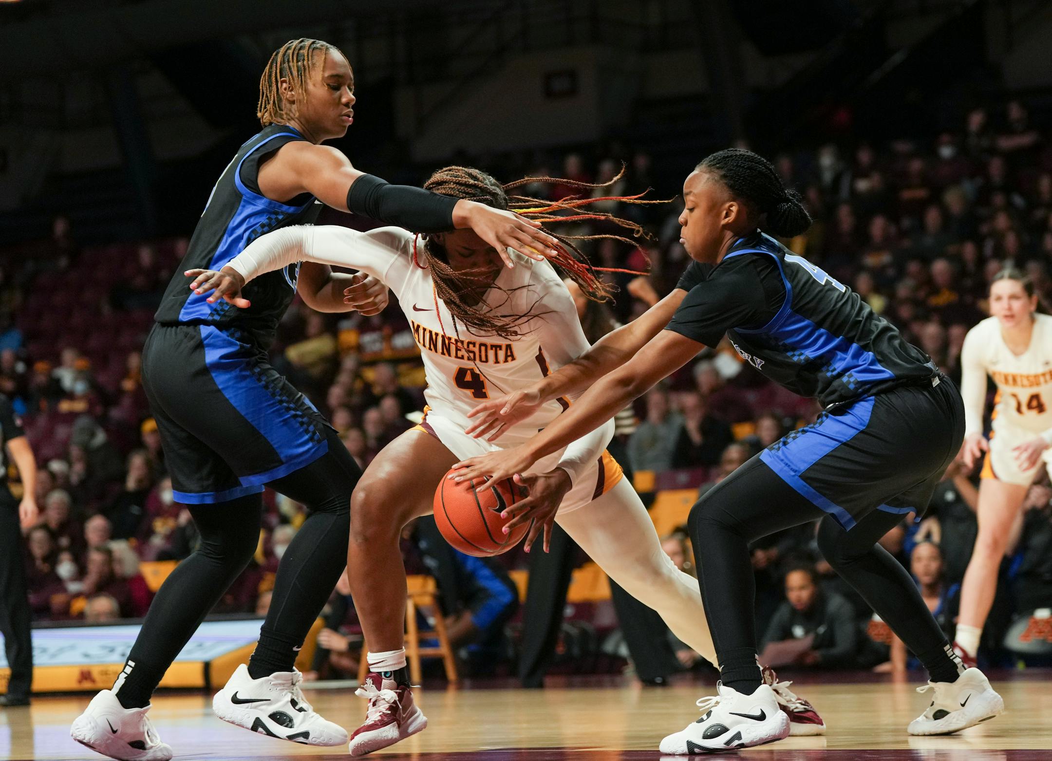 Minnesota Gophers forward Alanna Micheaux (4) gets tangled with Kentucky Wildcats forward Ajae Petty (13) and Kentucky Wildcats guard Eniya Russell (4) which led to a travel turnover in the first half.