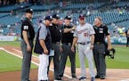 Tigers manager Ron Gardenhire poses with his son, Toby Gardenhire, and umpires, before a baseball game in Detroit on Sept. 17