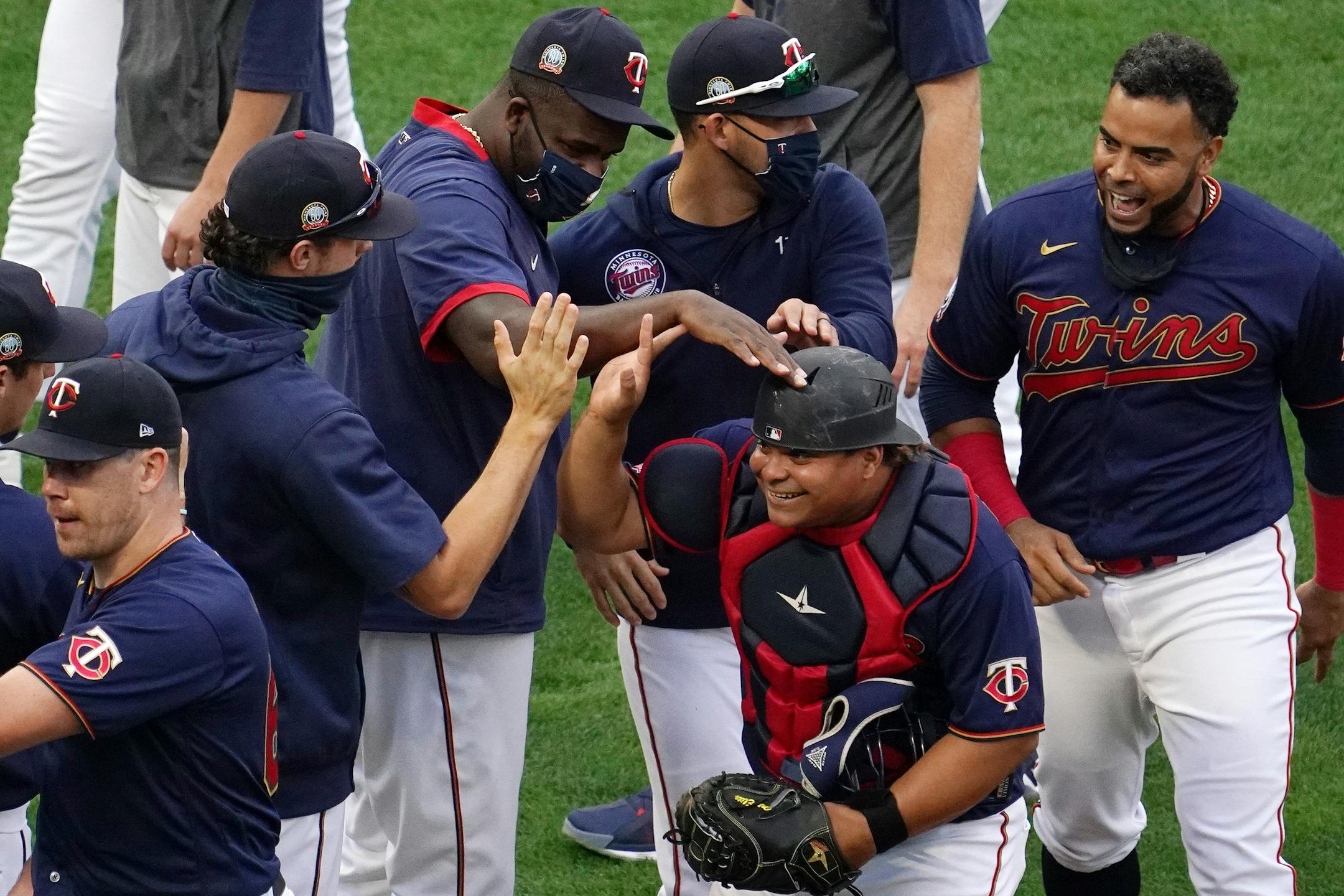 Twins catcher Willians Astudillo (64) was mobbed by his teammates at the end of the game. He earlier scored the game-winning run in the eighth inning. The Twins were playing as the visiting team.