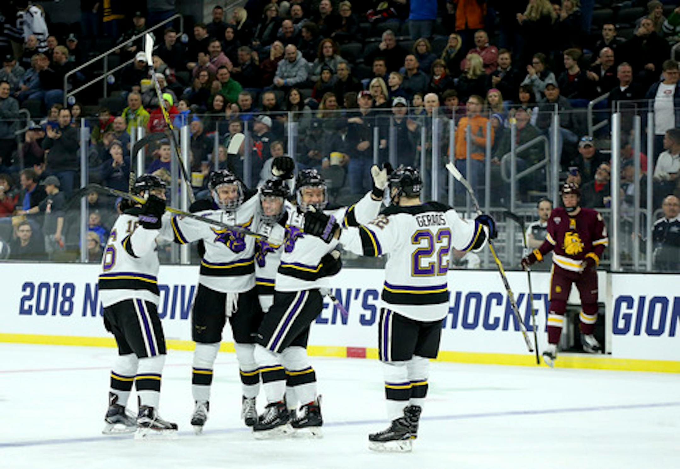 Mankato celebrates a power-play goal as Minnesota Duluth's Dylan Samberg (4) steps out of the penalty box during the first period of an NCAA regional men's college hockey tournament game, Friday, March 23, 2018, in Sioux Falls, S.D. (AP Photo/Dave Eggen)