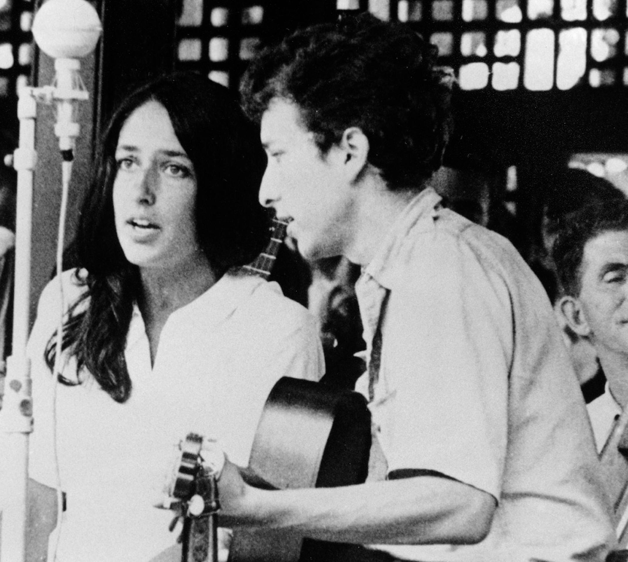 In this 1963 file photo, Joan Baez and Bob Dylan perform at the Newport Jazz Festival in Newport, R.I. Two years later, on the night of July 25, 1965, Dylan strode onto a stage at the Newport Folk Festival, plugged in an electric guitar and gave the music world a shock. Fifty years later, it�s considered one of the most important events in rock history, the high-voltage moment when Dylan broke from folk and helped show his fellow musicians the poetic possibilities of rock.