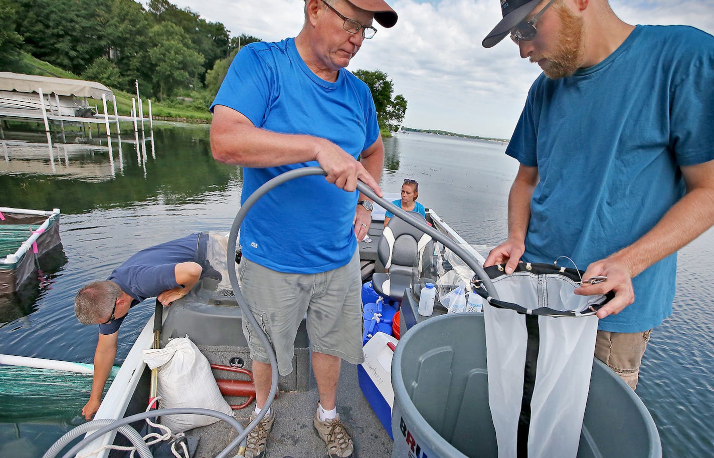 Minnehaha Creek Watershed District AIS Program Manager Eric Fieldseth, far left, University of Minnesota AIS Research Center's Dr. Michael McCartney, center, and Max Kleinhans, tested a project targeting tiny zebra mussels with low doses of a copper-based pesticide in Robinson Bay on Lake Minnetonka, Wednesday, July 20, 2016 in Wayzata, MN. ] (ELIZABETH FLORES/STAR TRIBUNE) ELIZABETH FLORES &#x2022; eflores@startribune.com