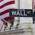 In this Aug. 8. 2011 photo, a Wall Street sign hangs near the New York Stock Exchange, in New York. Stocks tanked again Tuesday, Aig. 9, as many globa