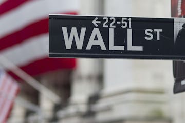 In this Aug. 8. 2011 photo, a Wall Street sign hangs near the New York Stock Exchange, in New York. Stocks tanked again Tuesday, Aig. 9, as many globa