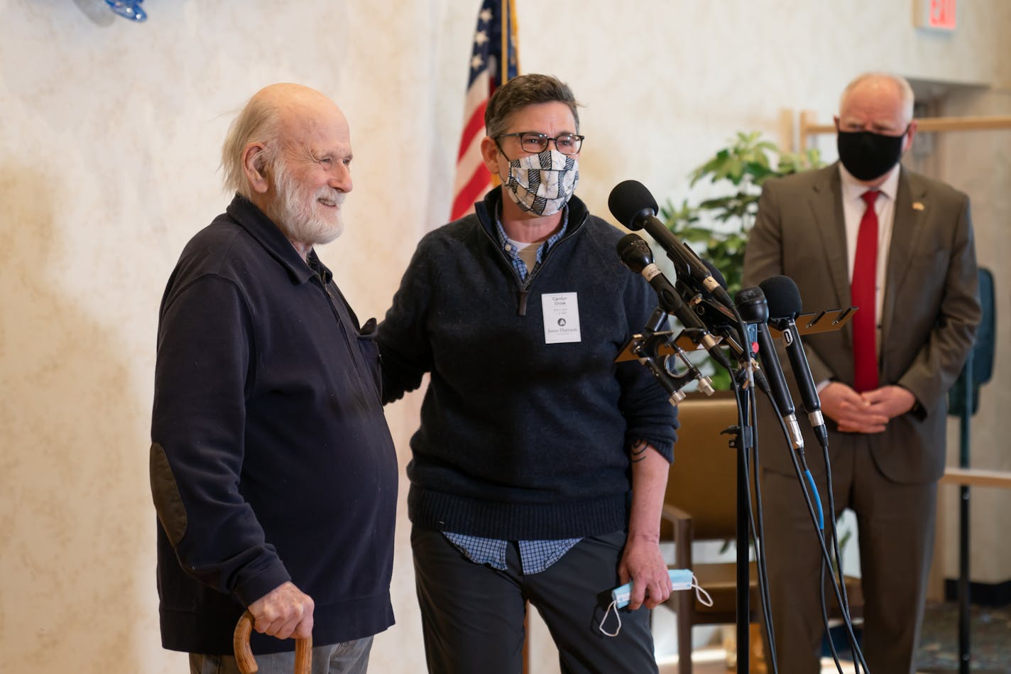 Gov. Tim Walz listened as resident Peter Grose and his daughter Carolyn Grose talked about the importance of the vaccine and the care he has received. Walz visited the Jones-Harrison Residence nursing home in south Minneapolis, to highlight the state's progress in vaccinating seniors in long-term care facilities.