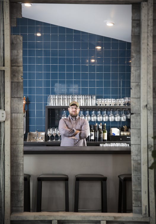 Chef/owner Erick Harcey in the restaurant's cozy blue-tiled bar.