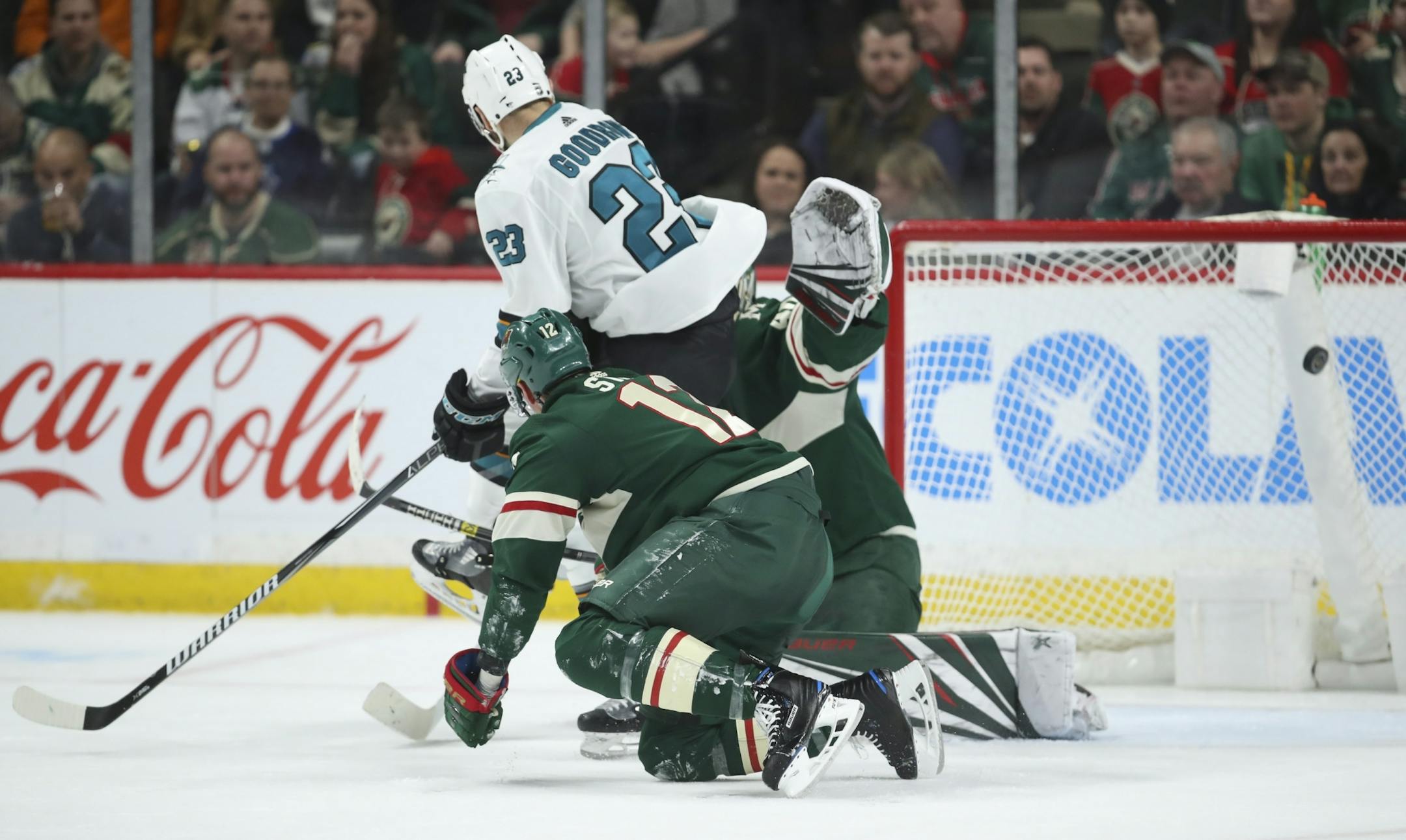 A second period shot deflected off San Jose Sharks right wing Barclay Goodrow (23) in front of Minnesota Wild goaltender Devan Dubnyk (40) for the first goal of the game.
