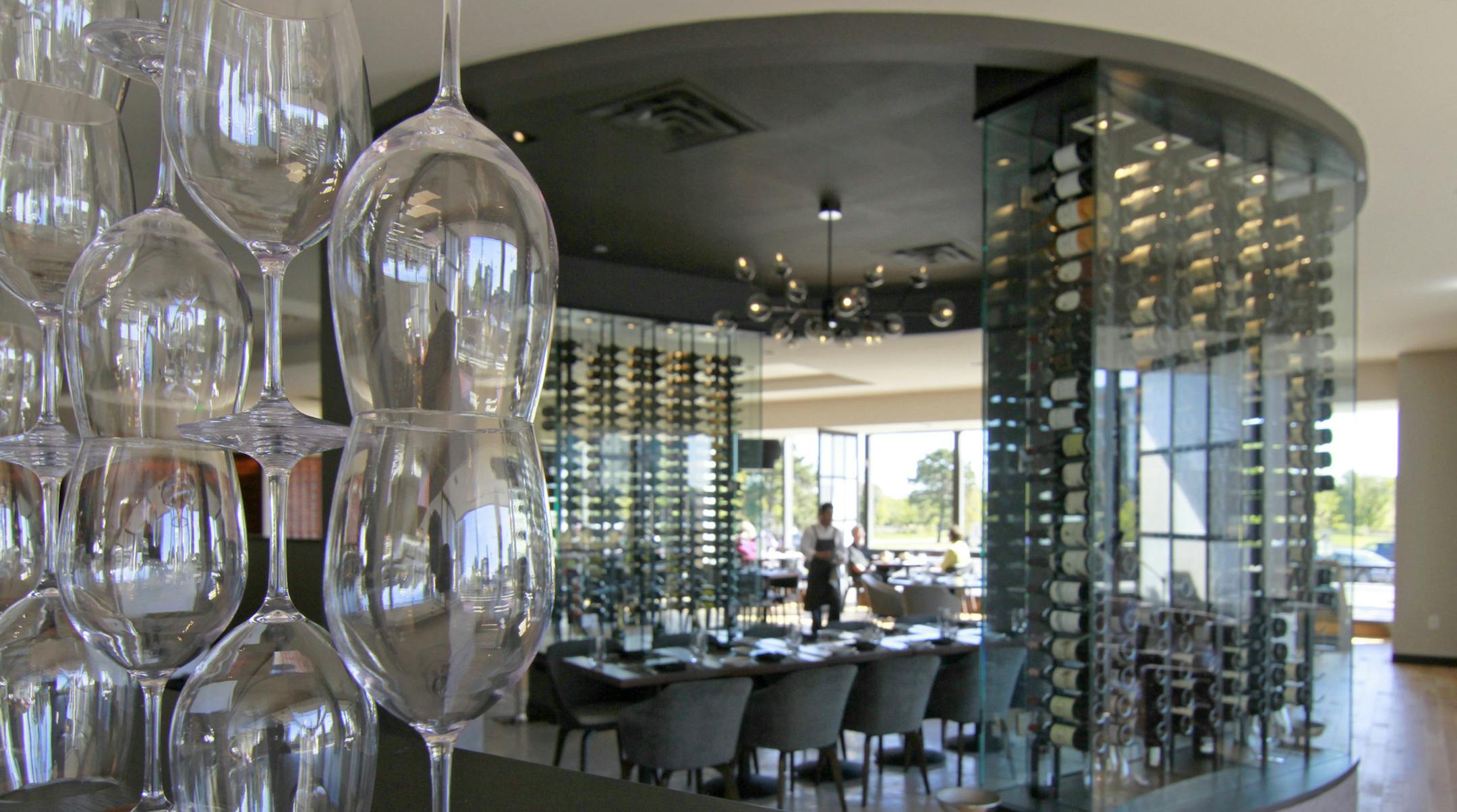 Restaurant review, - Lela, - Interior, a divider of wine glasses seperates the bar area and the dining room, with a group table situated inside see-through wine racks ] Tom Sweeney, Star Tribune, October 01, 2015, Bloomington, MN