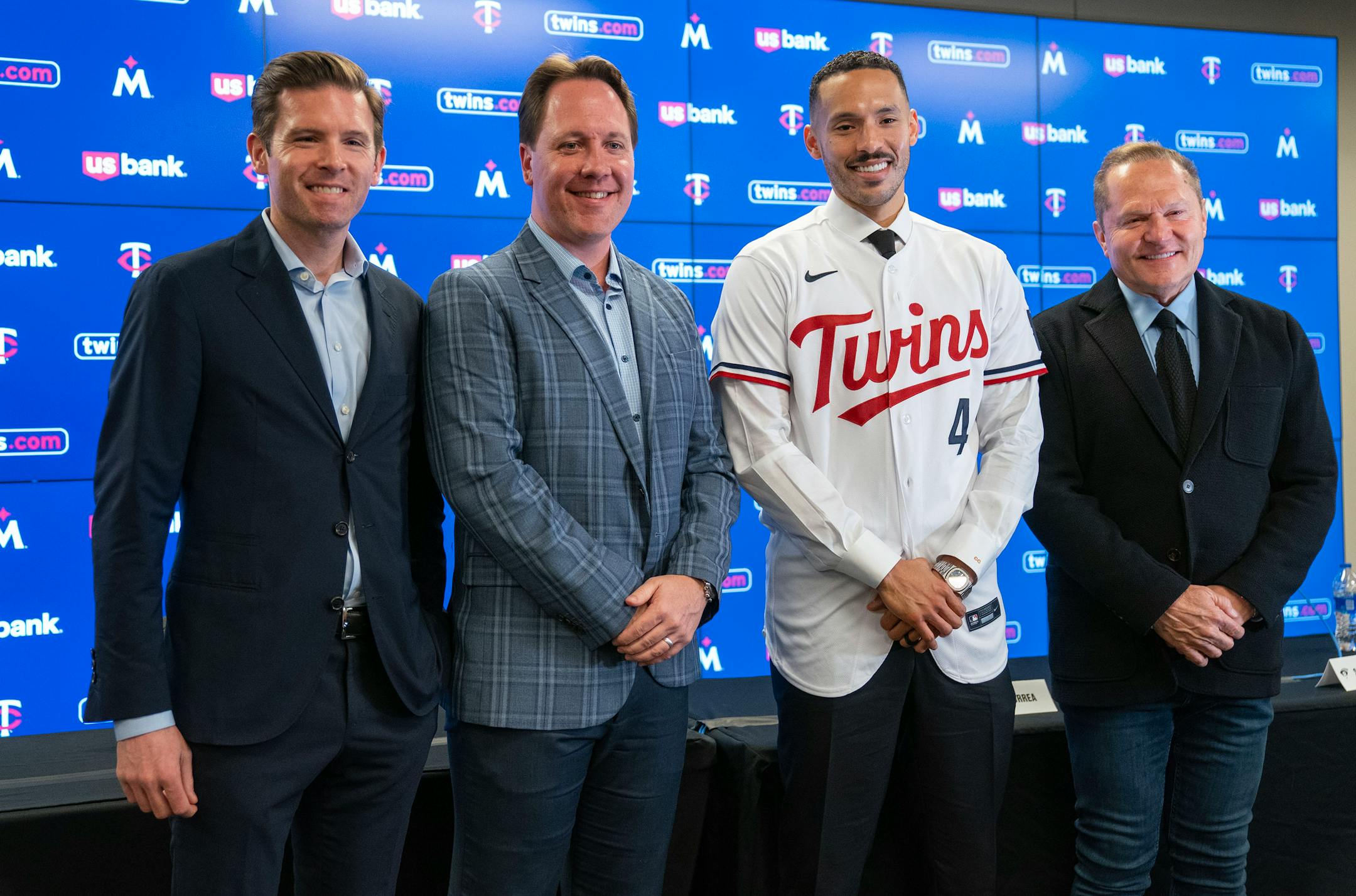 Joe Pohlad, Minnesota Twins executive chair, Derek Falvey, President of Baseball Operations, Carlos Correa, shortstop, and Scott Boras, Correa's agent, left to right, pose for a photo after a press conference.