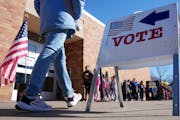 Voters walk past lines of students to cast their ballots for Tuesday's primary at Highlands Elementary School in Edina.