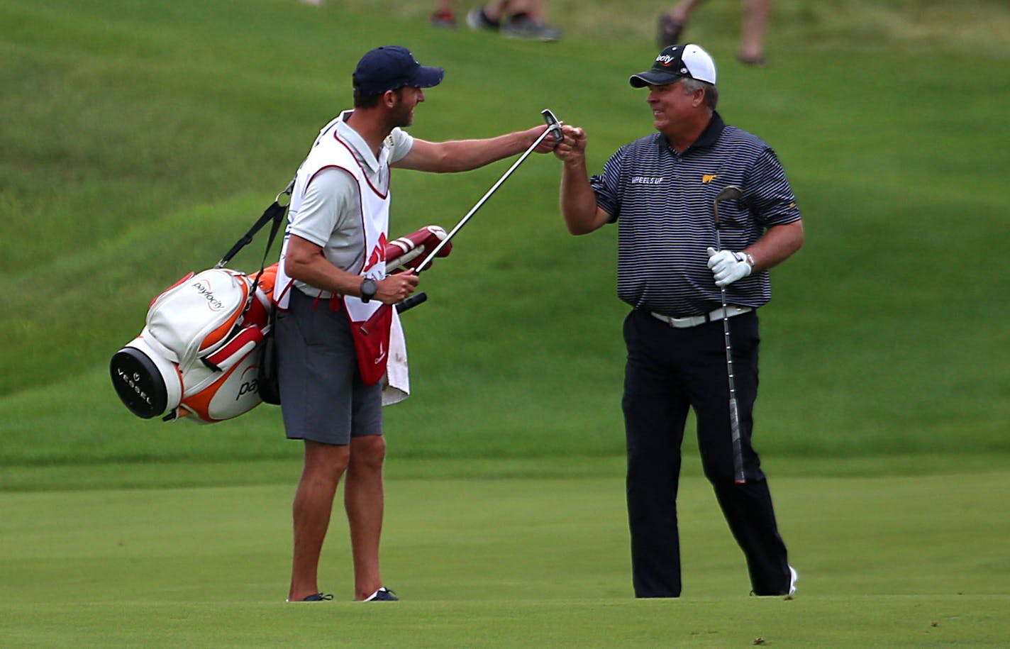 Kenny Perry fist bumps his caddy after hitting a perfect setup for an eagle on the 18th hole at the 2018 3M Championship. ] ALEX KORMANN � alex.kormann@startribune.com The final day of the 3M Championship took place on Sunday August 5, 2018 at TPC Twin Cities. Kenny Perry led going into the final round and never relinquished that lead despite a strong performance from Wes Short Jr., who finished only three strokes behind.