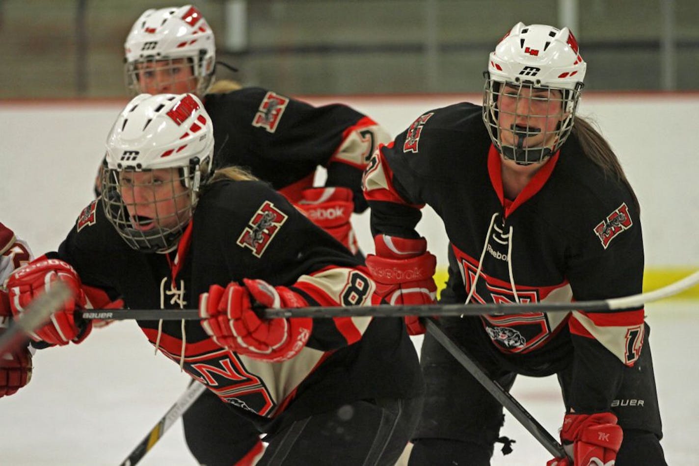 Lakeville North's Kelli Pritzlaff (8), Maddie McGlade (7) and Taylor Flaherty (19), defended against Lakeville South during a game earlier this month. Photo by BRUCE BISPING • bbisping@startribune.com