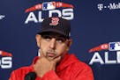 Boston Red Sox manager Alex Cora listens to a reporter's question before a baseball workout at Fenway Park, Thursday, Oct. 4, 2018, in Boston, in prep
