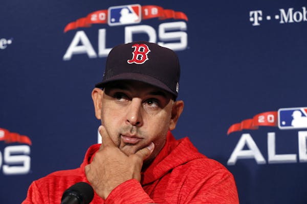 Boston Red Sox manager Alex Cora listens to a reporter's question before a baseball workout at Fenway Park, Thursday, Oct. 4, 2018, in Boston, in prep