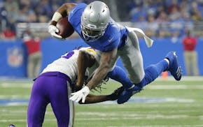 Minnesota Vikings cornerback Trae Waynes upends Detroit Lions running back Ameer Abdullah during the second half of an NFL football game, Thursday, No