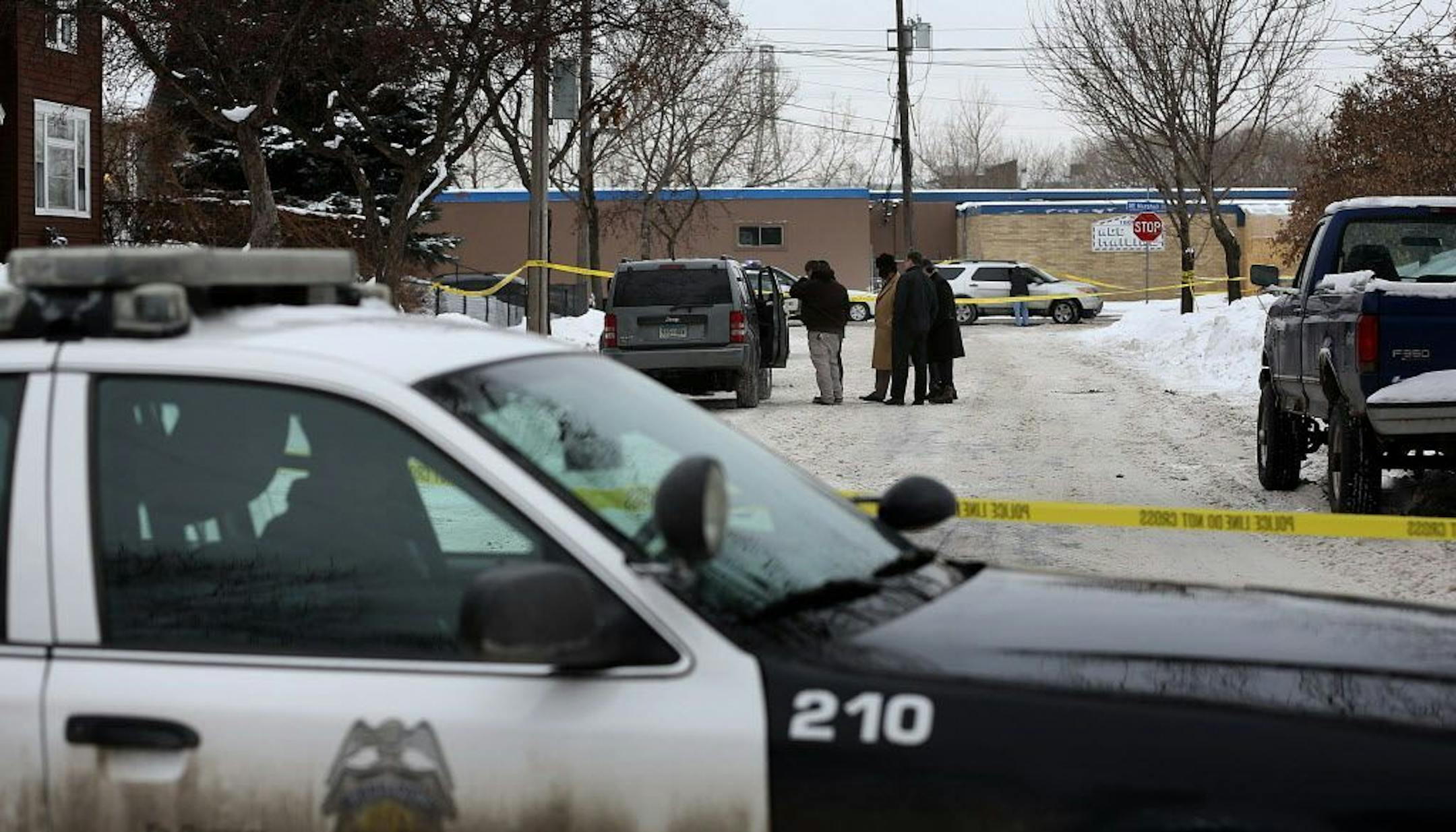 Police officers investigated an area along NE 16th Ave. near NE Marshall St., where federal agents were involved in gunfire while taking Buck O. White into custody in January 2014.