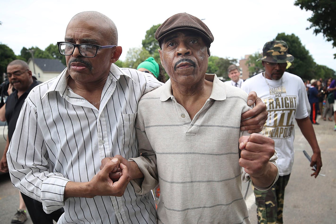 Thurman Blevins' uncle Manuel Moore, left, escorted his brother Thurman Moore after a protest and rally Sunday at the Minneapolis' Fourth Precinct.