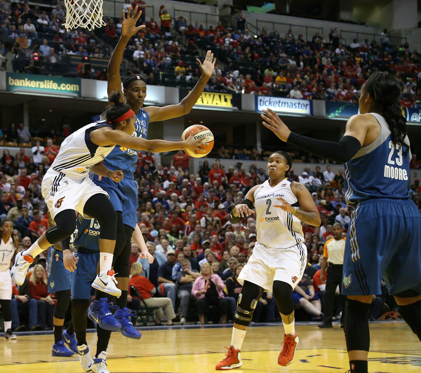 Indiana guard Briann January, off her feet but not off her game, dished around Lynx center Sylvia Fowles to cutting teammate Erlana Larkins (2).