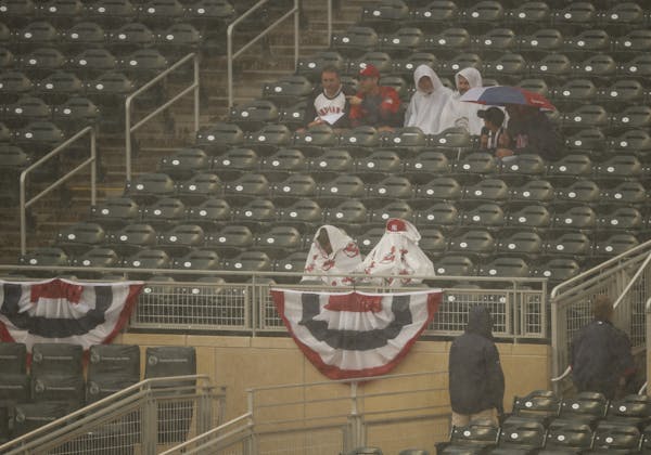 Fans waited out a brief rain shower that interrupted the National League team's batting practice before the Home Run Derby Monday afternoon.