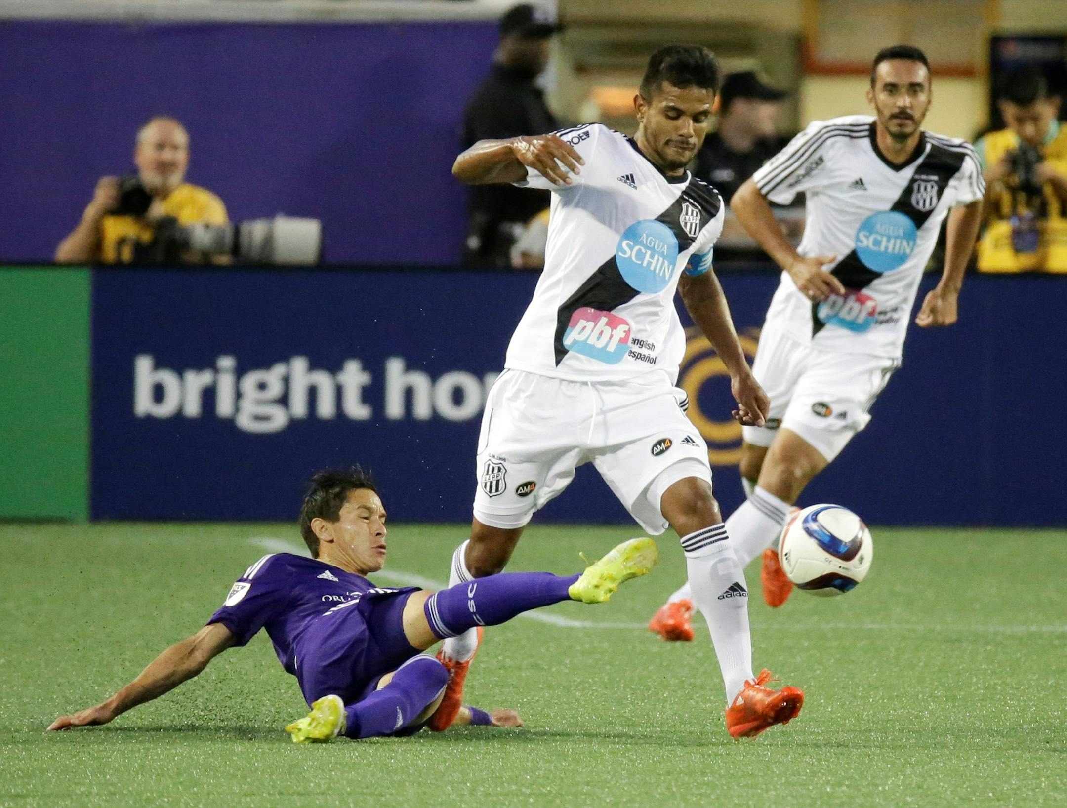 Orlando City defender Eric Avila, let, tries to get the ball away from Brazil's Ponte Preta midfielder Fernando Bob, center, during the first half of an international friendly soccer game, Saturday, May 2, 2015, in Orlando, Fla. (AP Photo/John Raoux) ORG XMIT: FLJR106