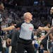 NBA referee Jacyn Goble gets between Nets forward Dorian Finney-Smith (28) and Timberwolves guard Nickeil Alexander-Walker during a February game at T