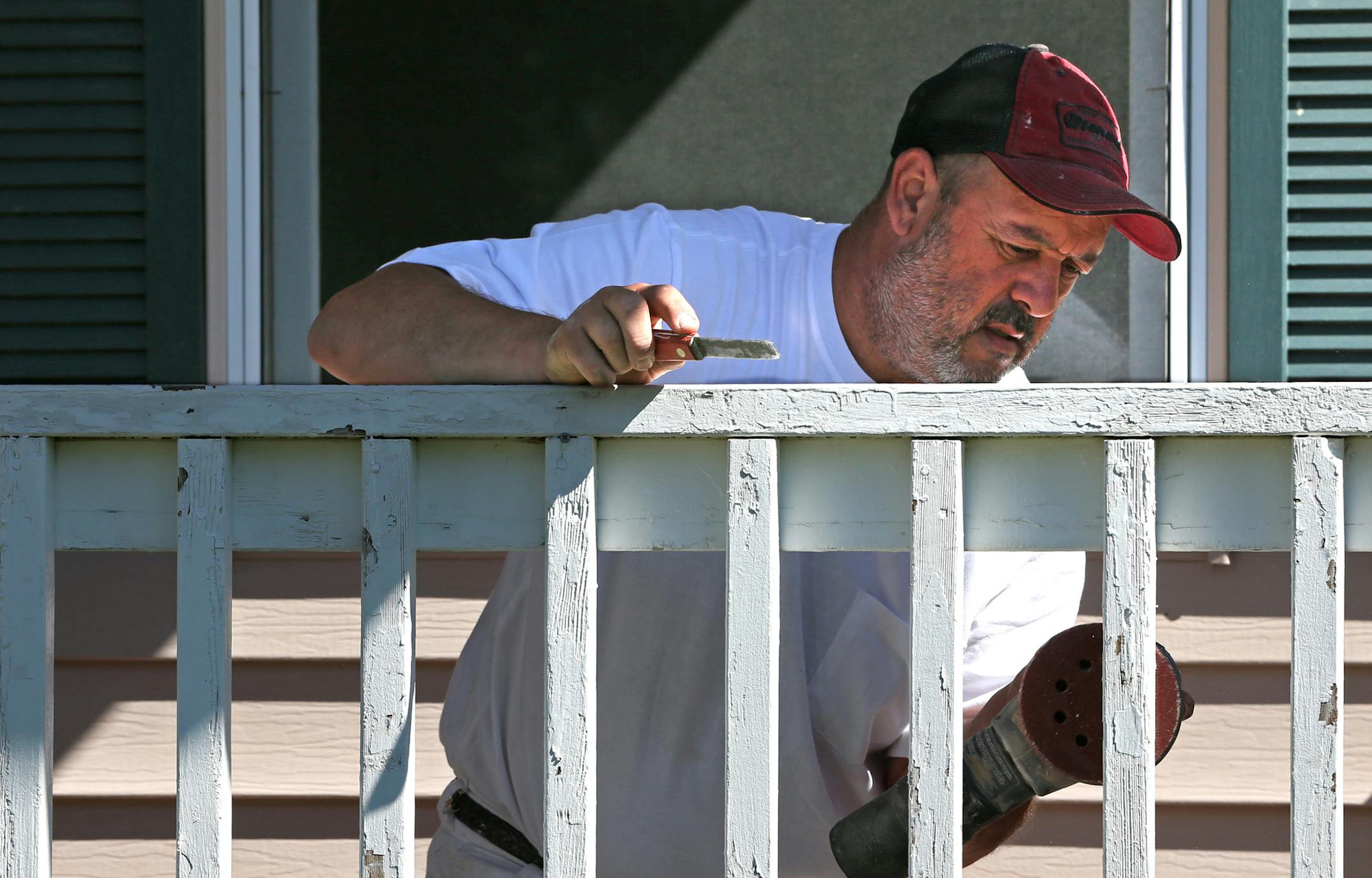 Kevin Stone worked on the porch railing of a Blaine house owned by Invitation Homes.