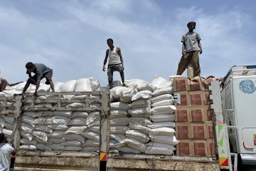 In this August photo, workers unloaded a food truck at a World Food Programme (WFP) distribution site in Zelazle in the Tigray region of northern Ethi